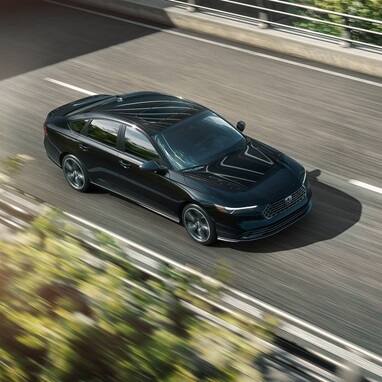 2026 Honda Accord in Crystal Black Pearl driving along overpass.